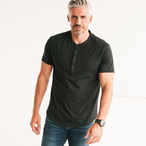 Batch Men's Essential Short Sleeve Curved Hem Henley – Black Cotton Jersey Image Standing on Body